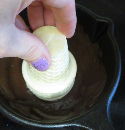 dipping ice cream cones into chocolate