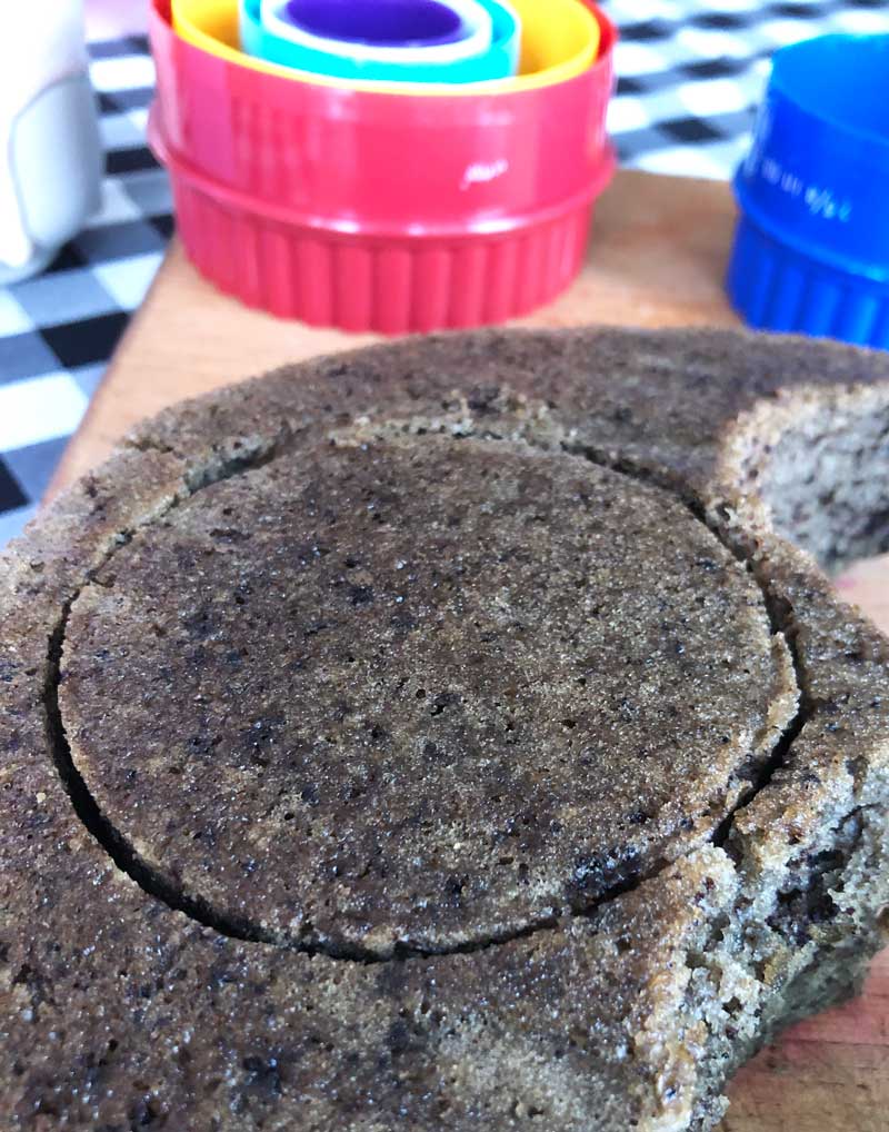 cutting circles out of the vegan oreo cake