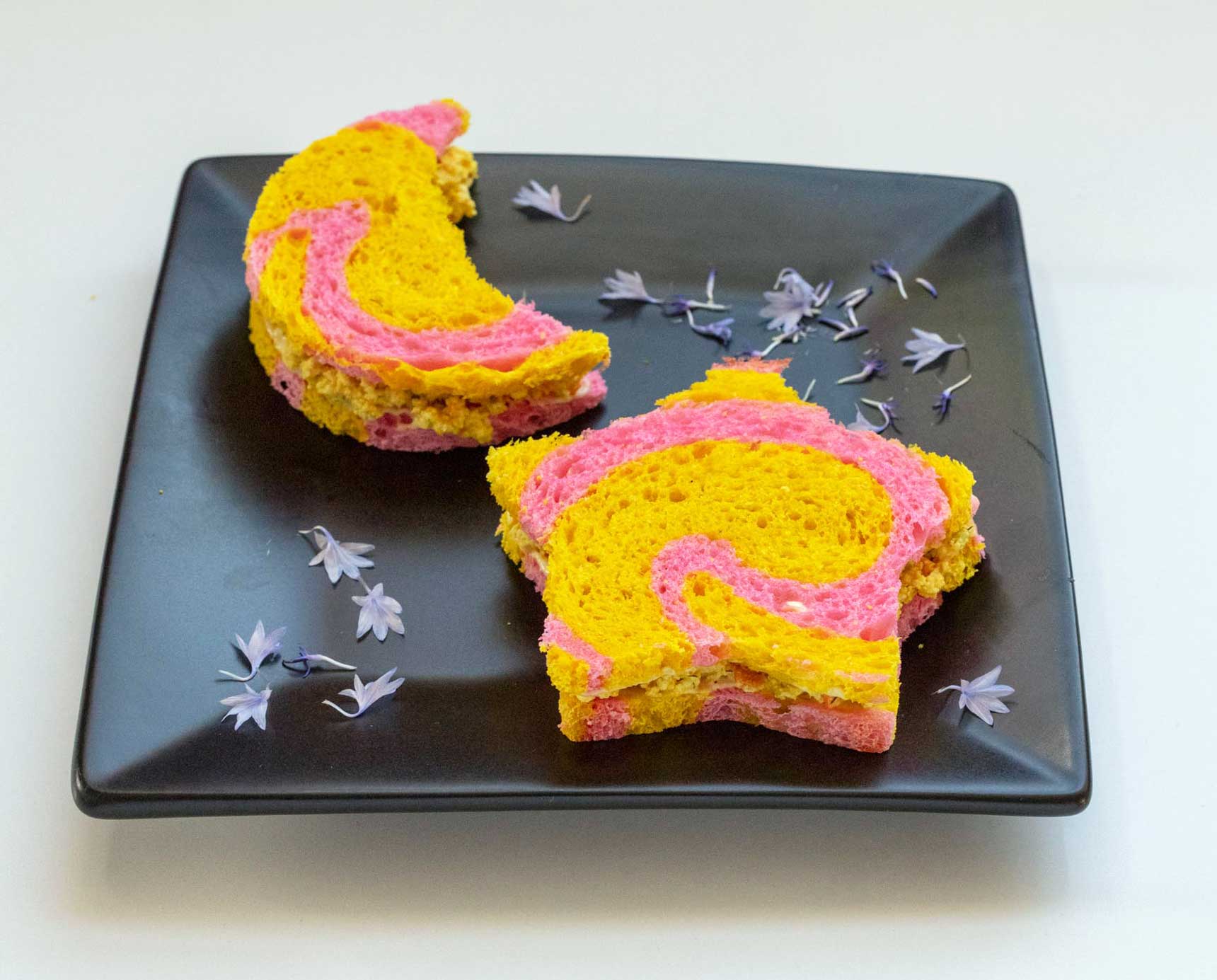 moon and star shaped tea sandwiches on pink and yellow bread.