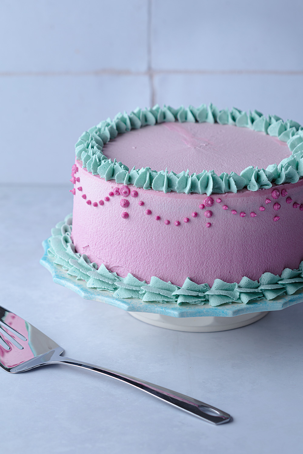 the completed nutella cake decorated with pink and teal frosting