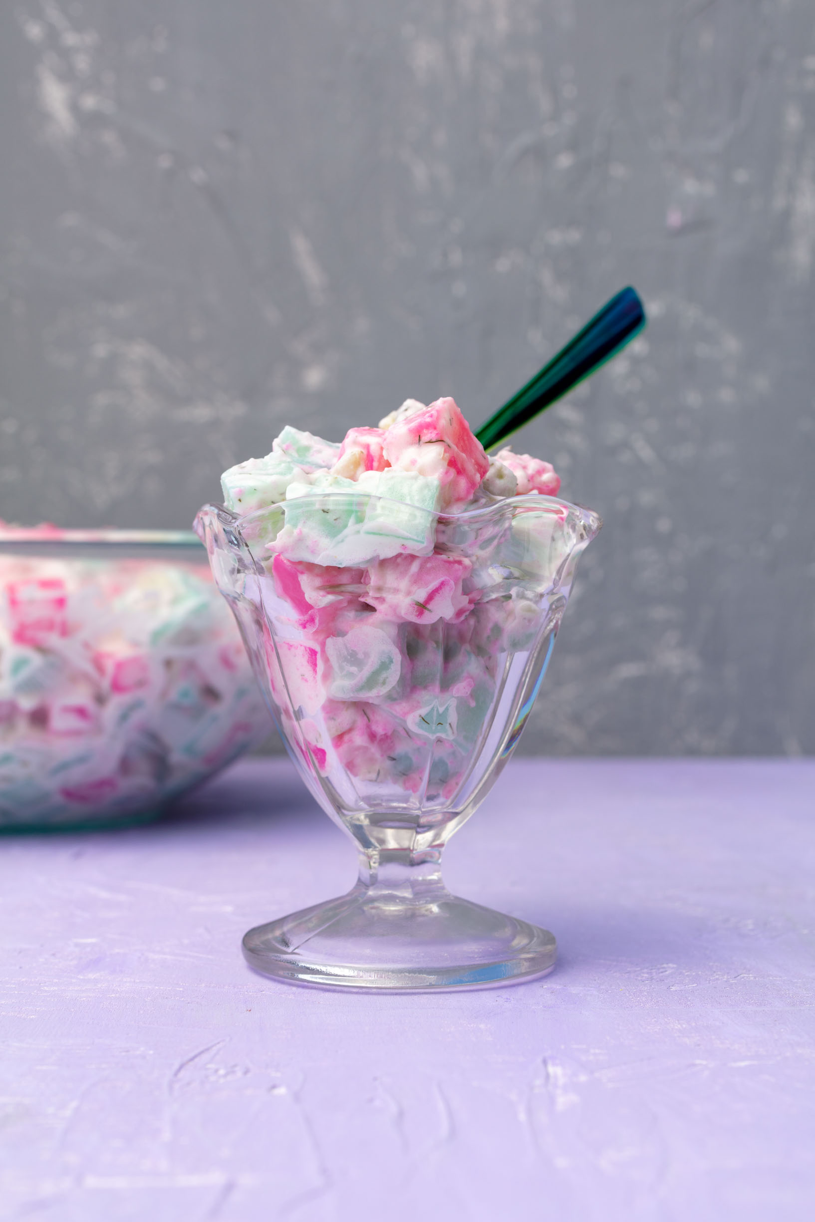 a vintage ice cream dish filled with pastel blue and pink potato salad.