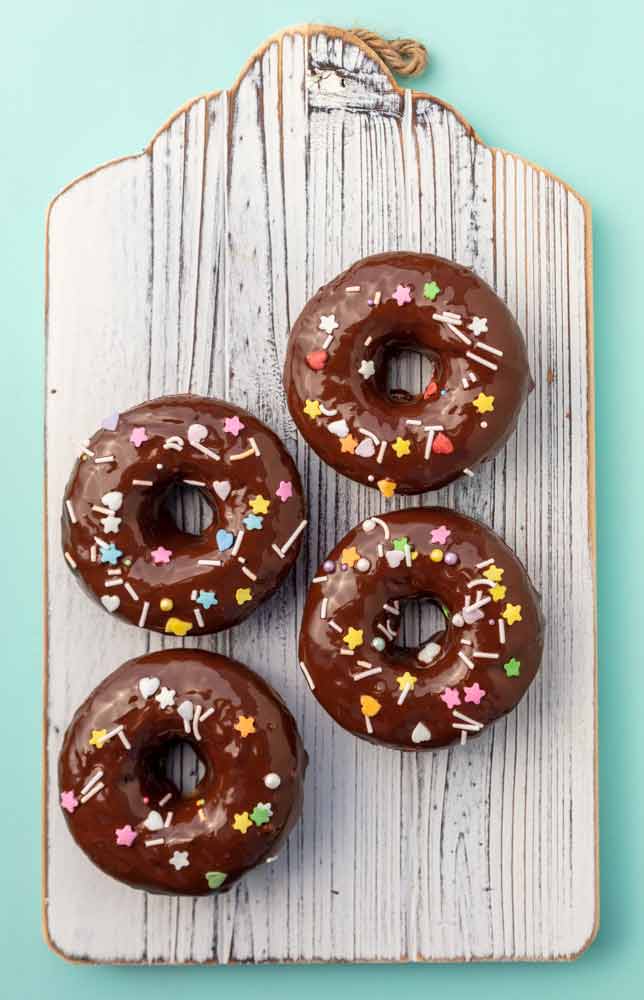 banana bread donuts with chocolate icing and sprinkles