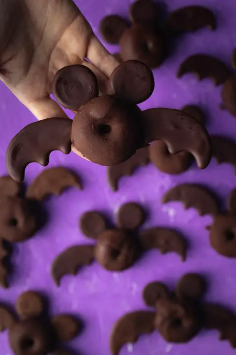 holding a mickey mouse bat vegan halloween donut