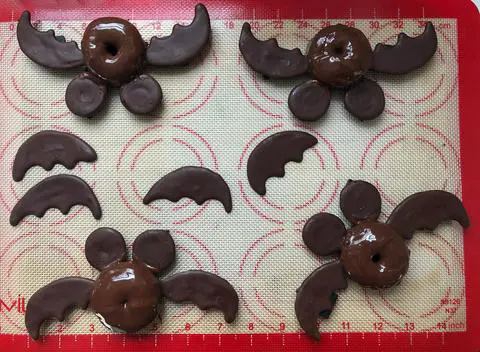 Adding mickey mouse ears and bat wings to my vegan halloween mini donuts