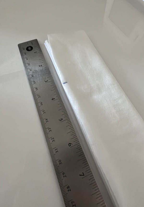 the narrow strip of fabric with a pen mark on the left side 3 and a half inches from the top