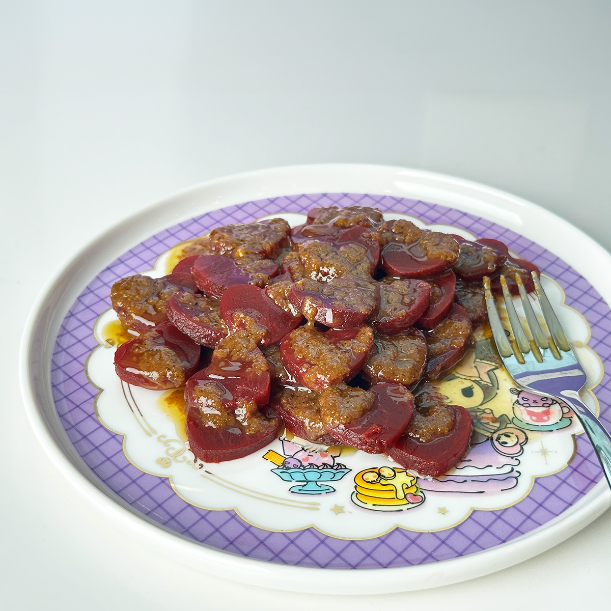 beet salad with dressing on a kuromi plate.