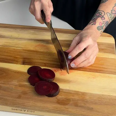slicing beets with a knife.