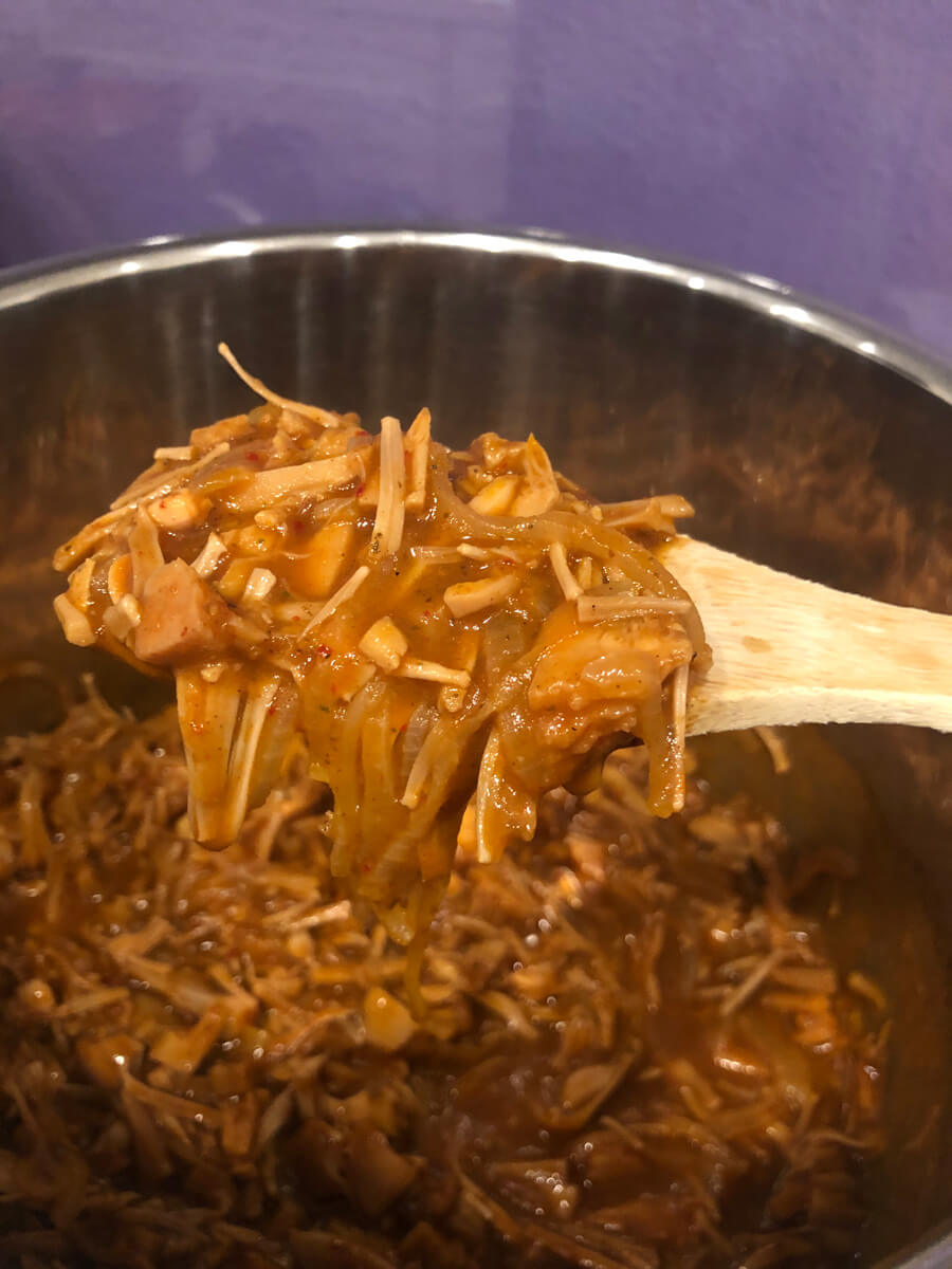 a scoop of cooked jackfruit birria