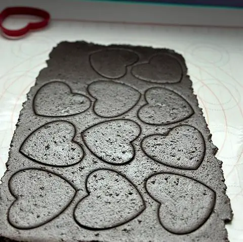 cutting black heart cookies from the black cocoa cookie dough