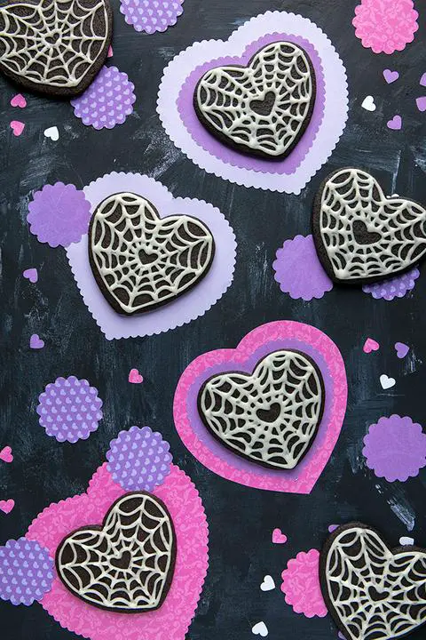 black heart goth core cookies decorated with spider web icing for Valentine’s Day