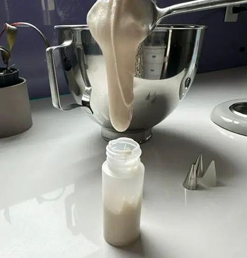 transferring the icing for goth valentine cookies to an icing bottle