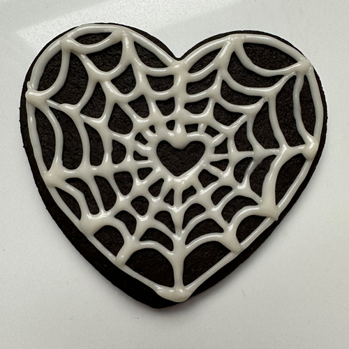 chocolate halloween heart cookies with mint spider web icing