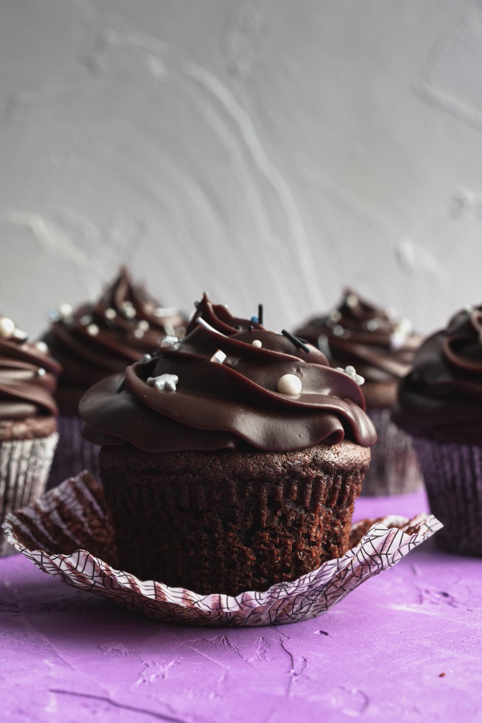 vegan chocolate cupcake with the wrapper peeled down