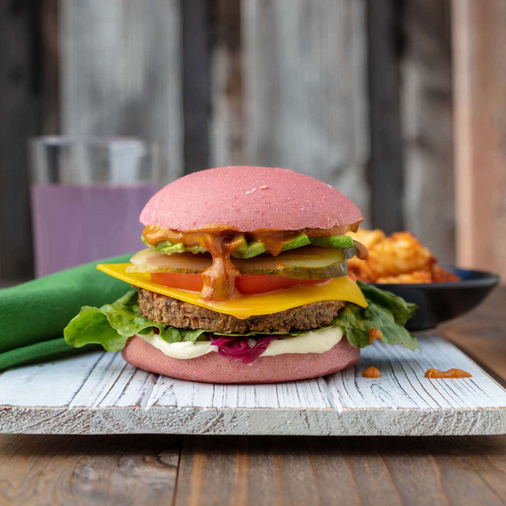 vegan burger on a pink colored bun