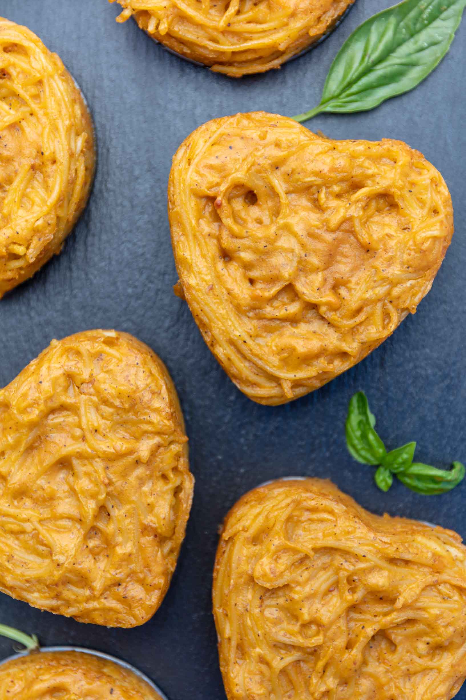 three heart shaped vegan cacio e pepe mini cakes