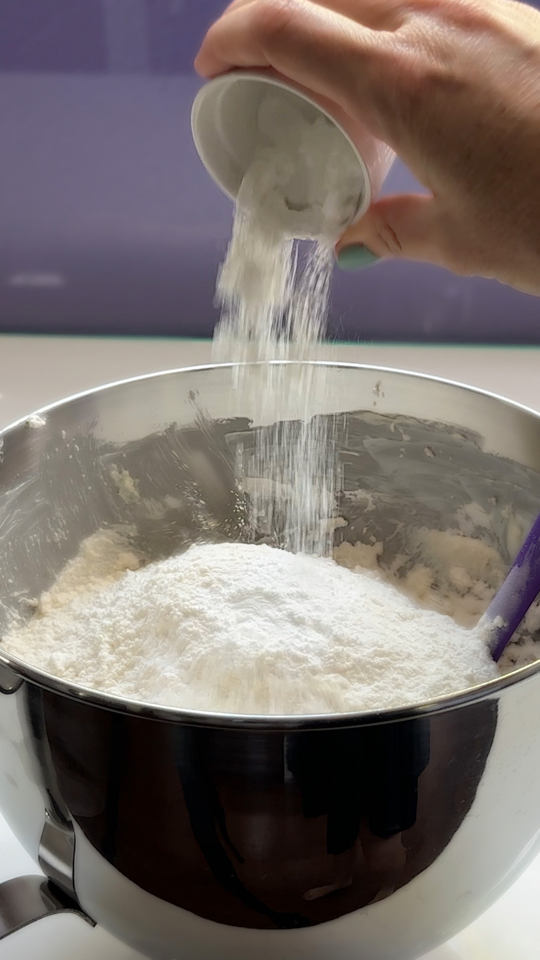 adding dry ingredients to the mixing bowl