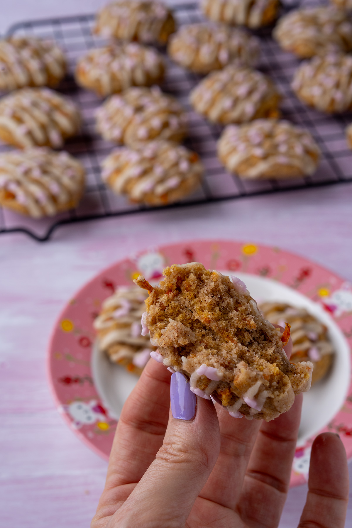 one carrot cake cookie broken in half showing the inside texture