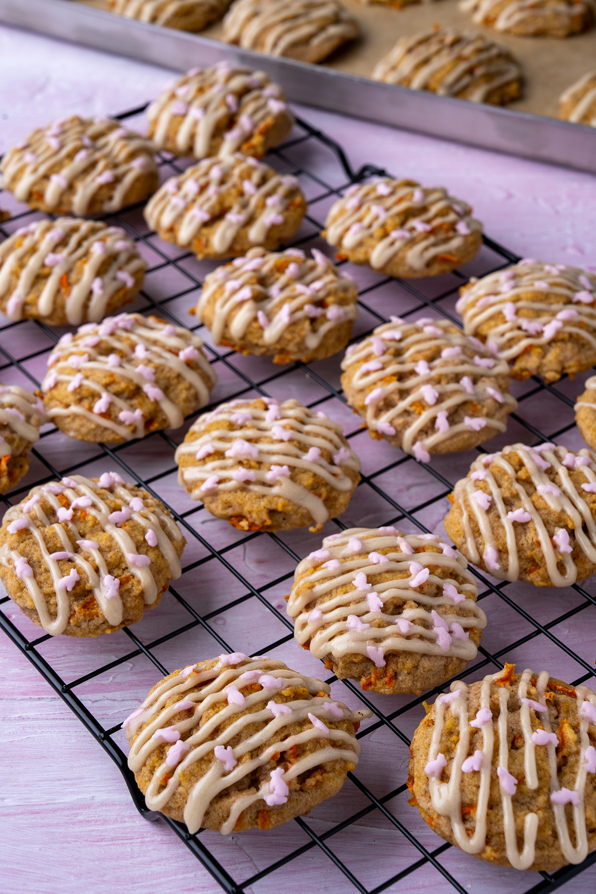 carrot cake cookies with cream cheese frosting drizzled on them