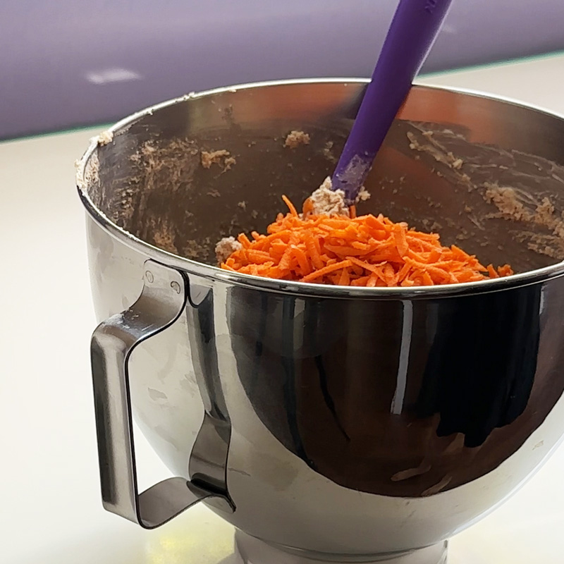 a pile of grated carrots in the mixing bowl.