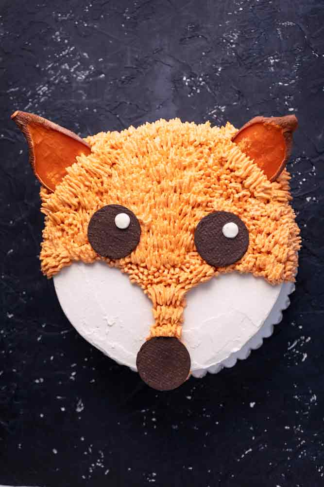 carrot cake decorated to look like a fox.