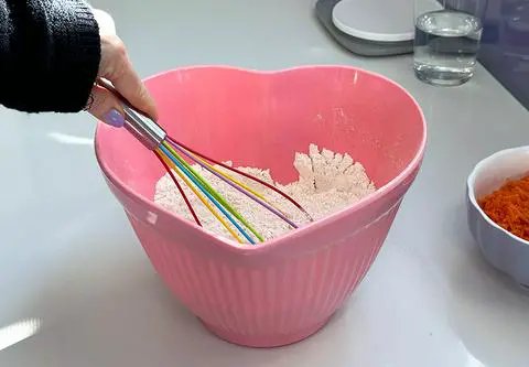 whisking the dry ingredients with a rainbow whisk.