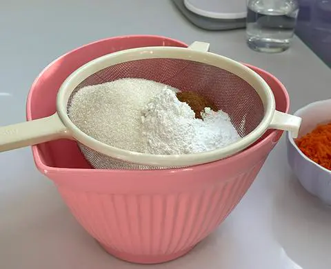 dry ingredients measured into a sifter and ready to sift.