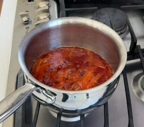 making candied carrots in a pot on the stove.