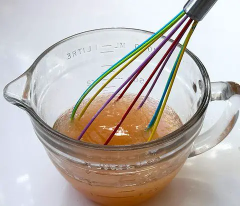 mixing the wet ingredients with a rainbow whisk.