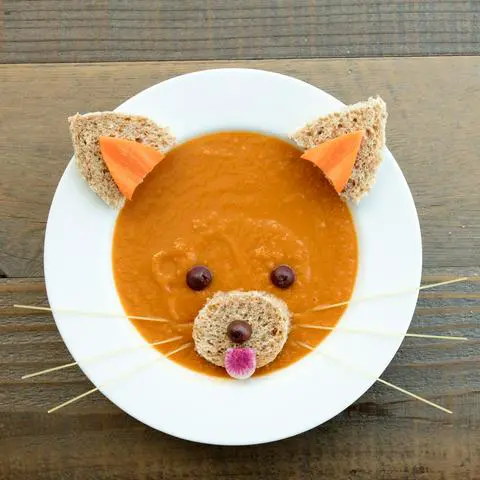 vegan carrot celery soup decorating to look like a red panda