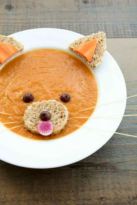 carrot celery miso ginger soup decorated to look like a red panda