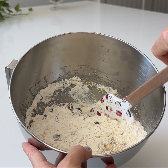 gently mixing the ingredients for the chocolate chip muffins with a hello kitty spatula