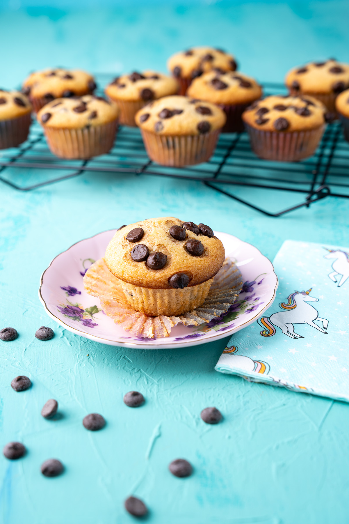 eggless chocolate chip muffins on a cooling rack with one on a plate