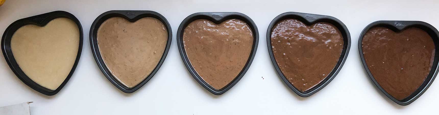 5 heart cake pans, filled and ready to go into the oven