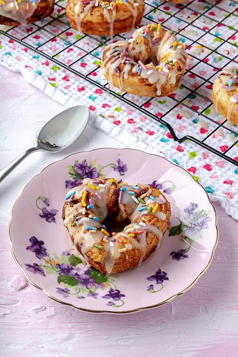 a heart-shaped cinnamon roll donut on a plate