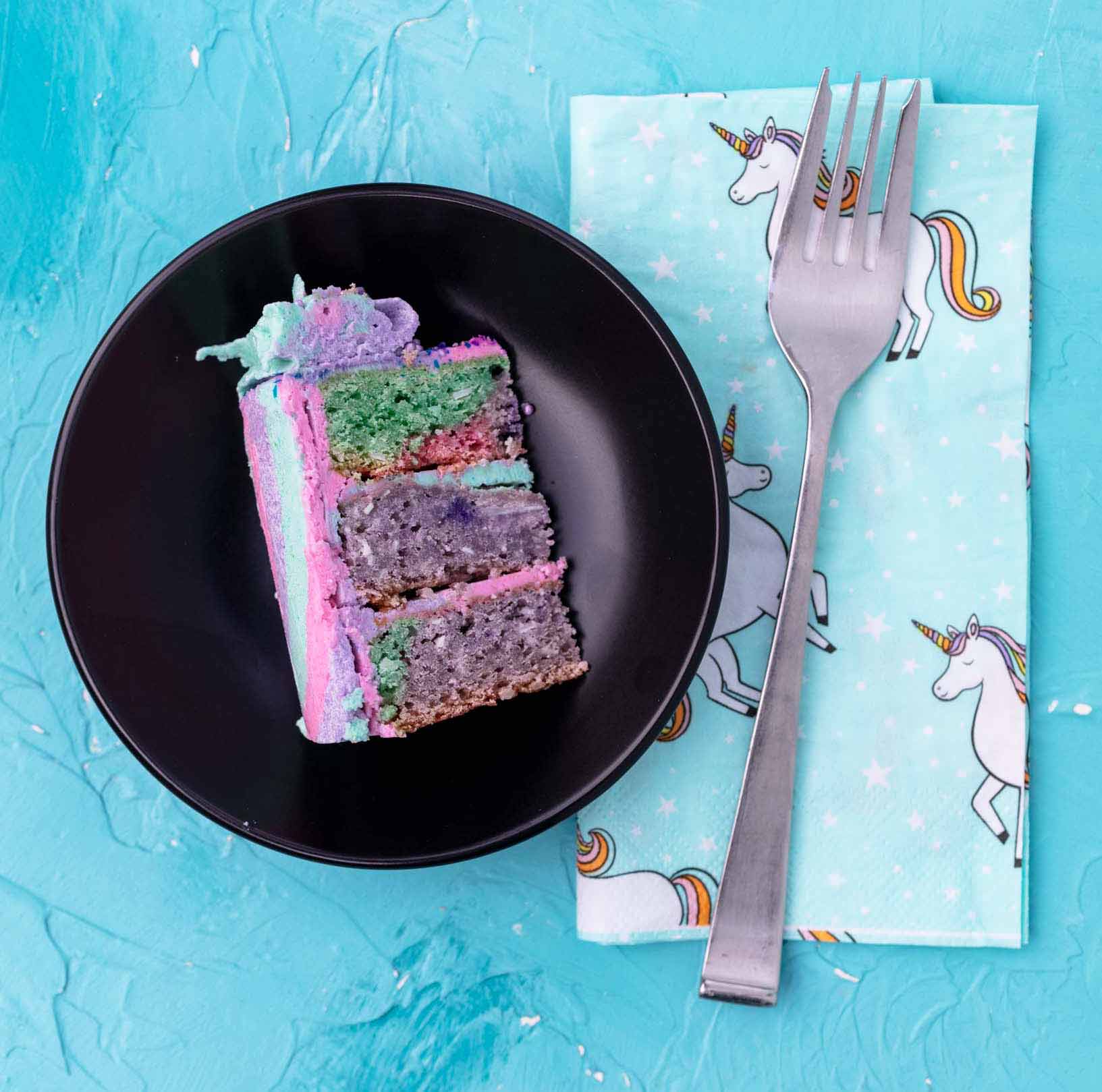 slice of coconut cake from a mini vegan pastel rainbow colored cake