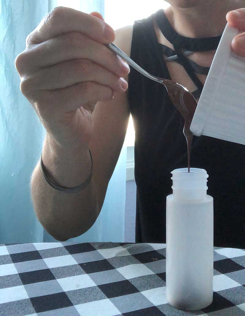transferring melted chocolate into a squeeze bottle