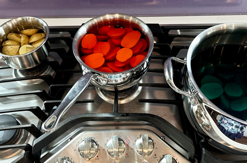 boiling the potatoes in colored water to make colored deviled potatoes