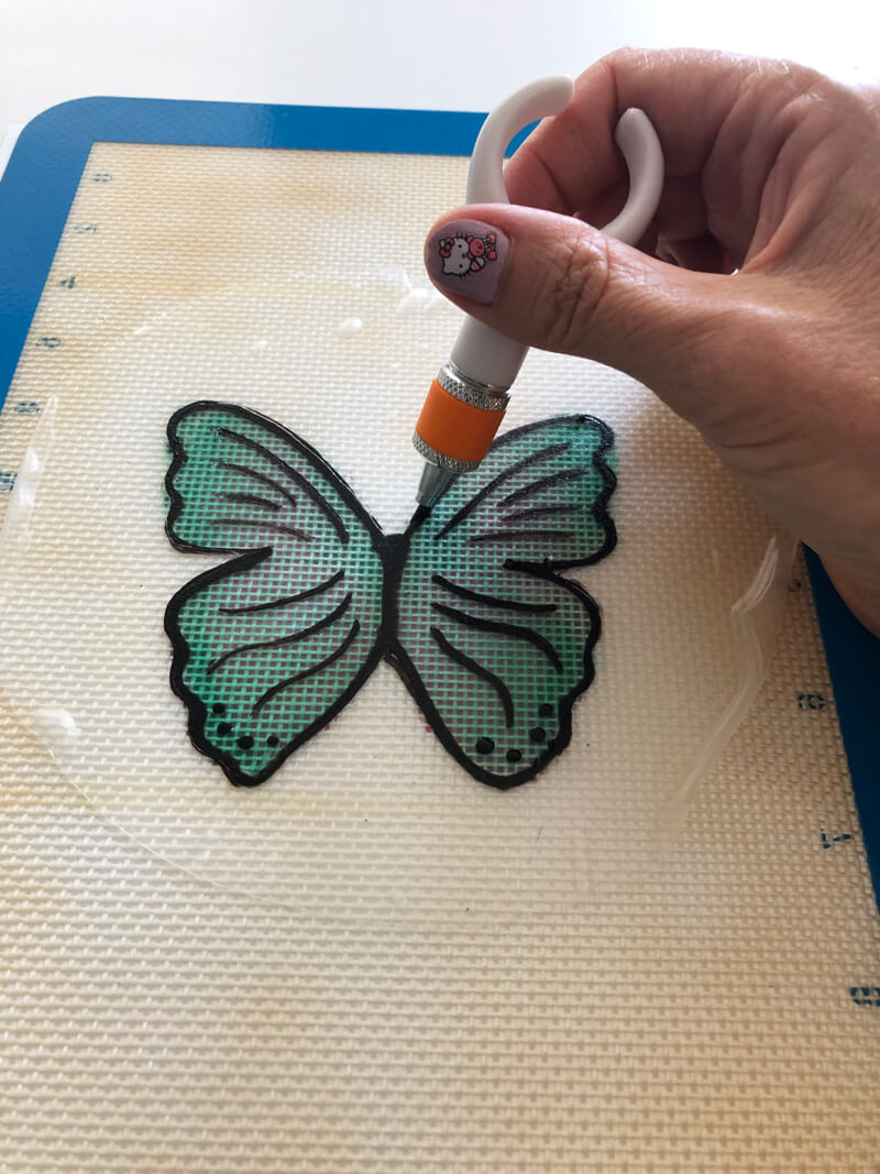 cutting out the butterfly using a swivel exacto knife