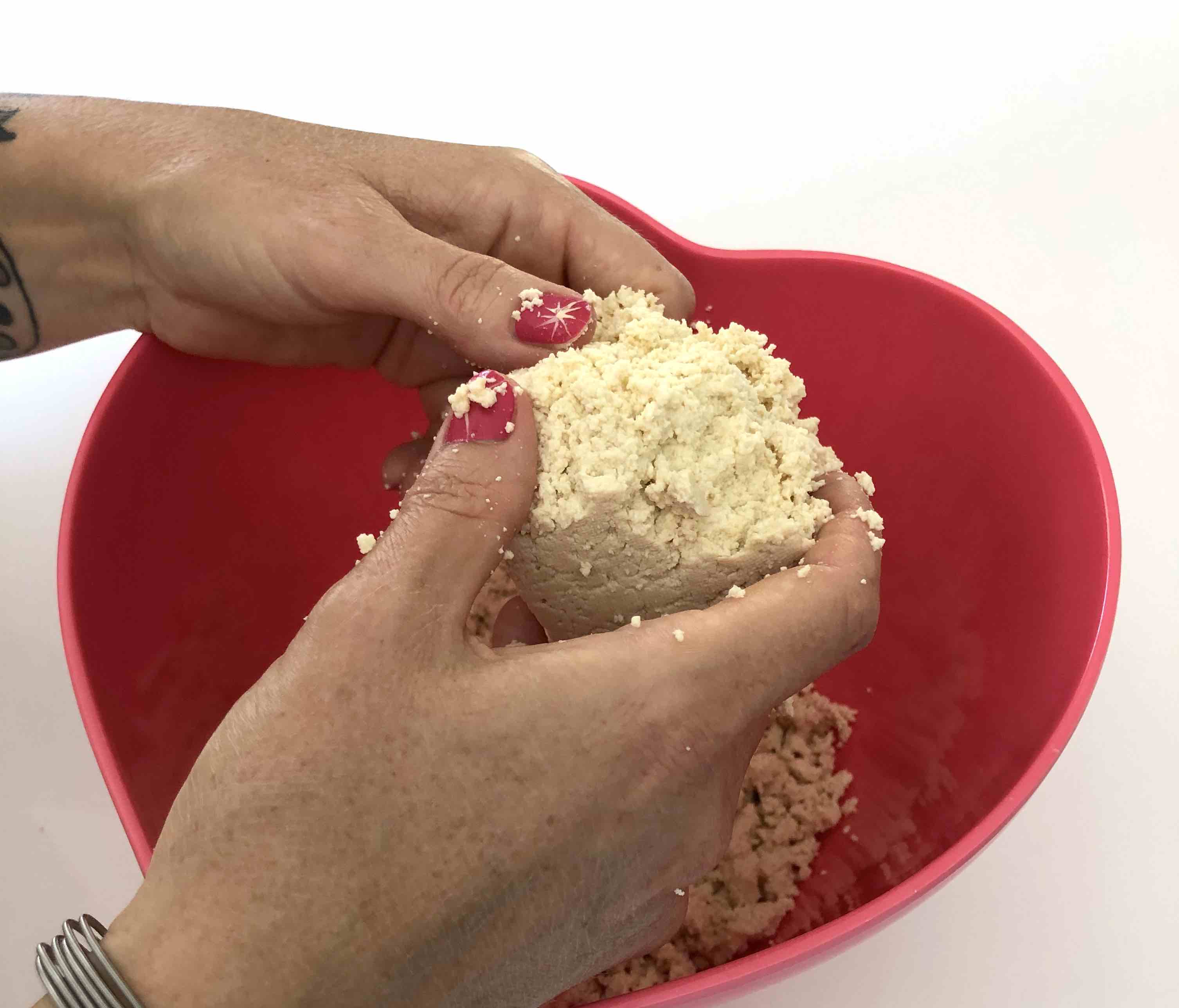 crumbling the tofu into the bowl