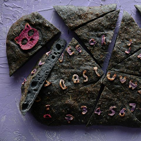vegan focaccia bread with ouija board art, baked and sliced