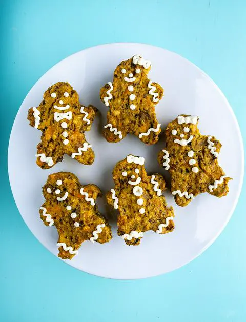 five single serving frittata that are decorated like gingerbread men.