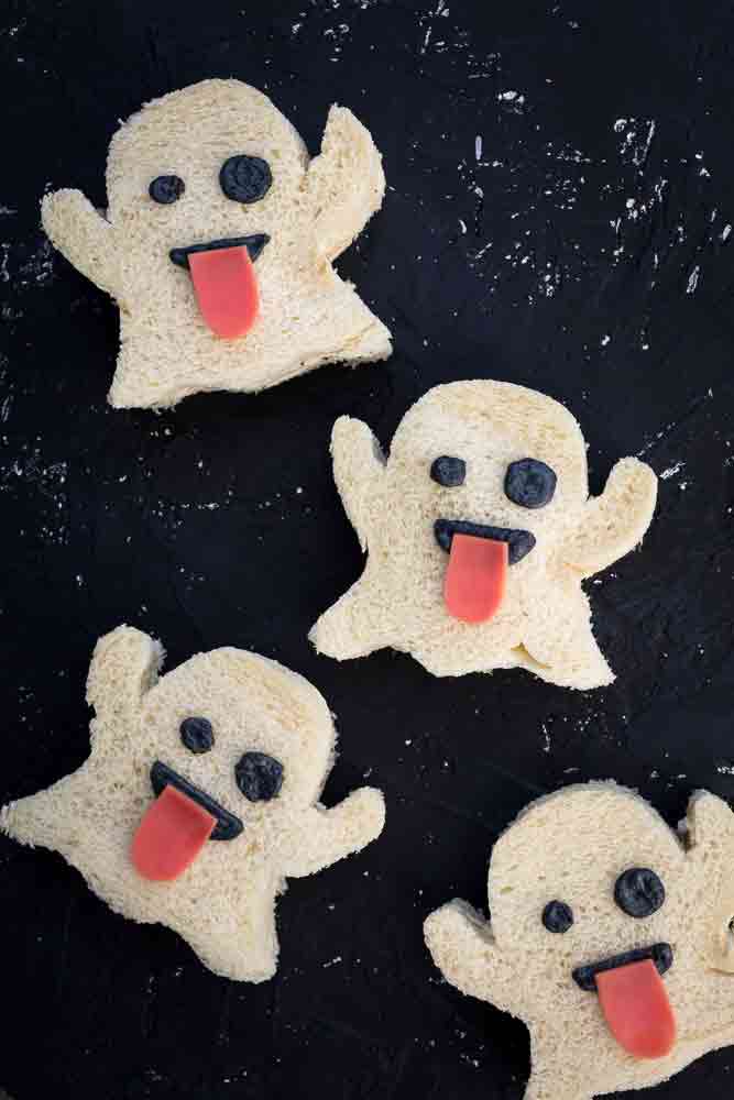 vegan halloween tea sandwiches that look like the ghost emoji