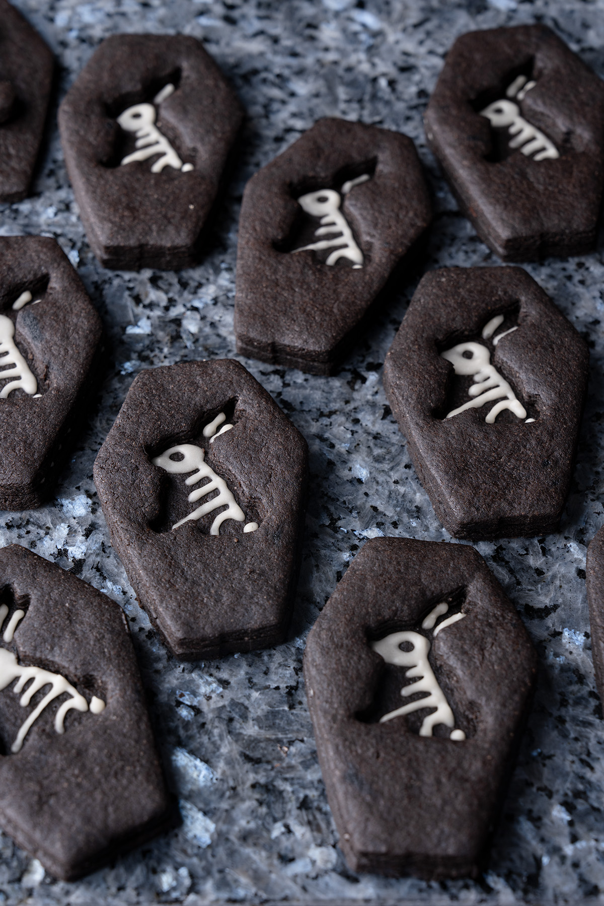 black coffin cookies on a cake plate