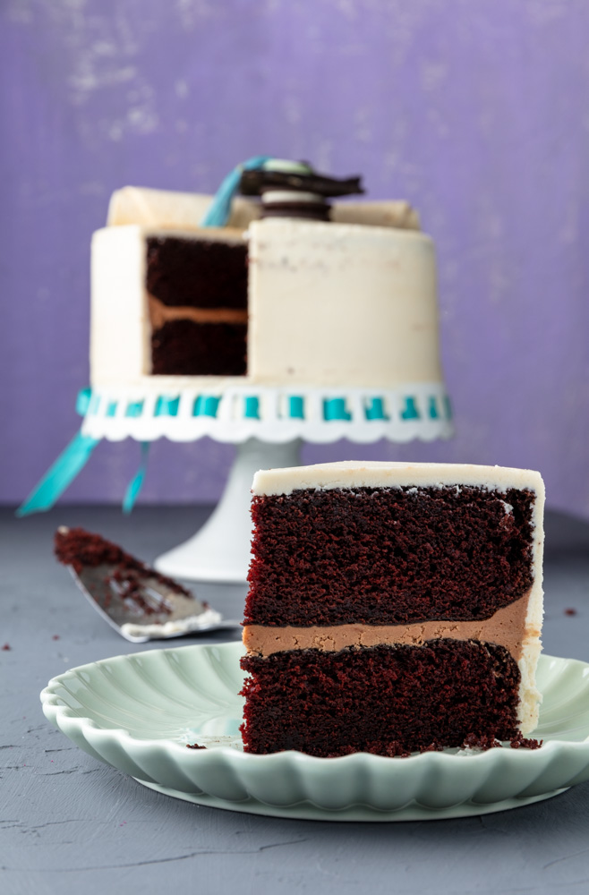 a slice of vegan chocolate cake decorated for a graduation