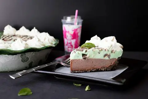 a slice of Vegan Chocolate Mint Chip Ice Cream Pie on a plate.
