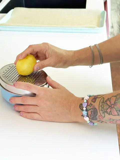 zesting lemons for the lemon blueberry cookies