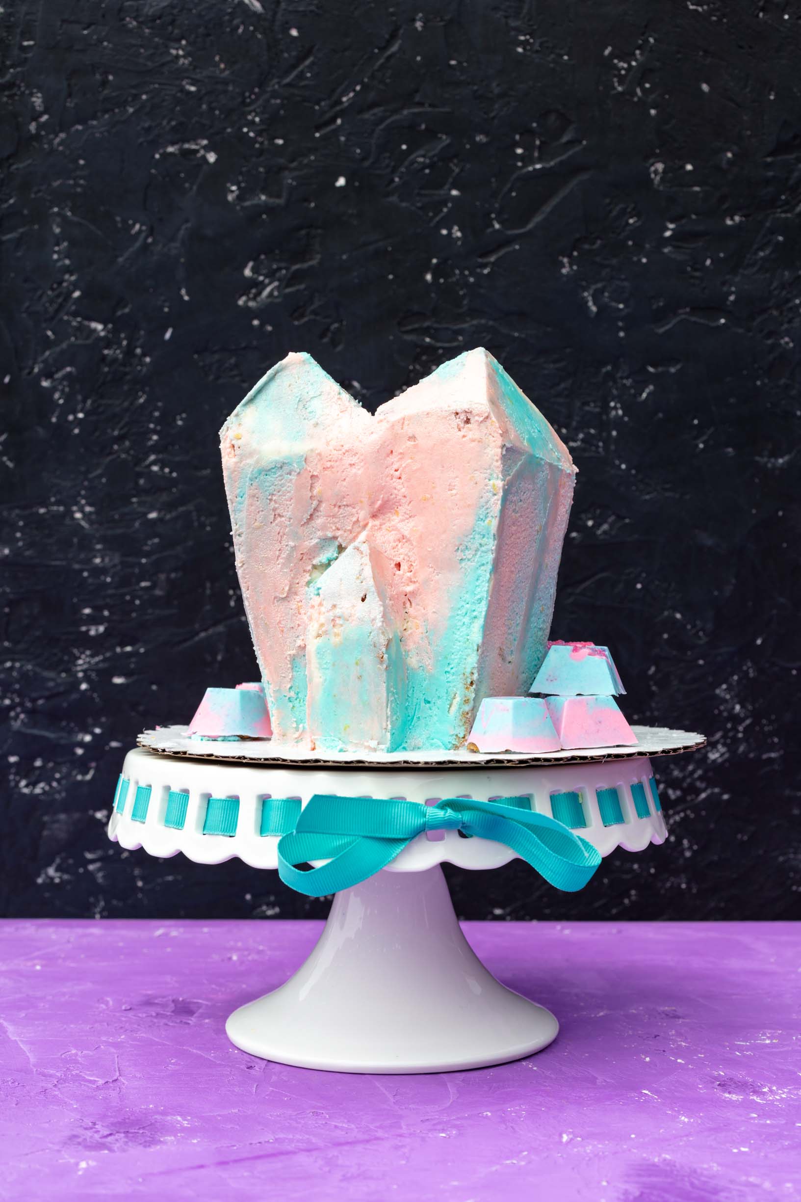 Vegan loquat crystal cluster cake with transgender flag colored lemon frosting