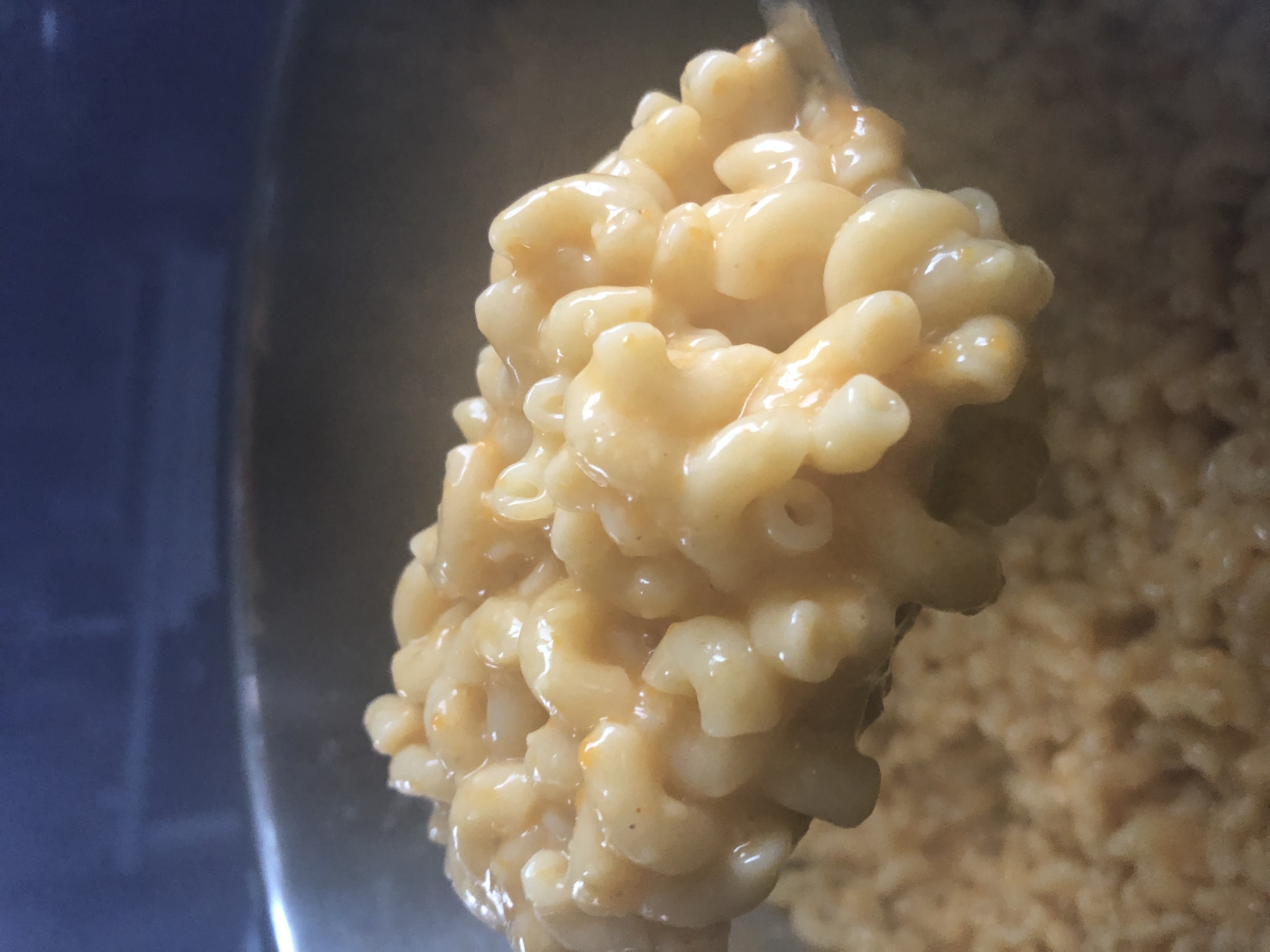 a scoop of the creamy mac and cheese after the vegan cheese melts into it