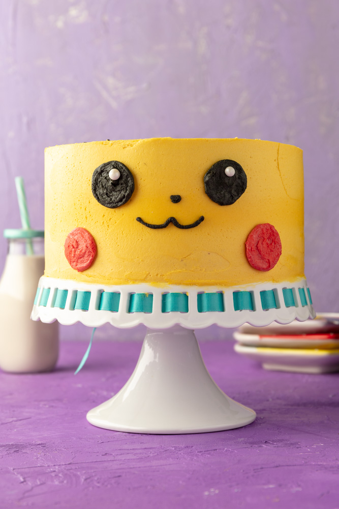 2-layer round vegan marble cake frosted and decorated to look like the pokemon pikachu