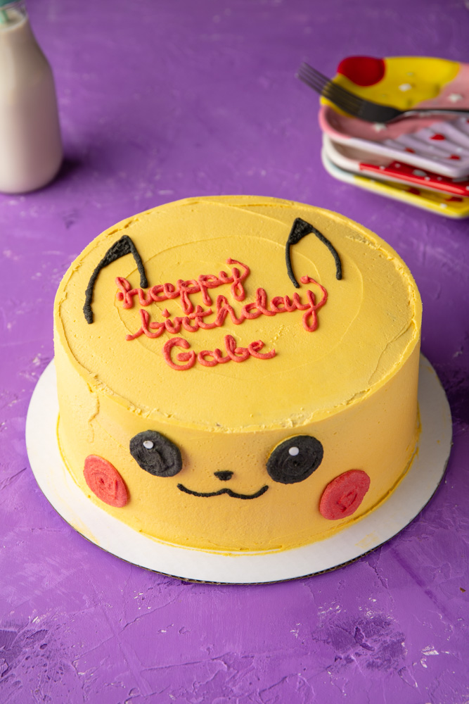 vegan pikachu pokemon cake with a birthday message written in red frosting